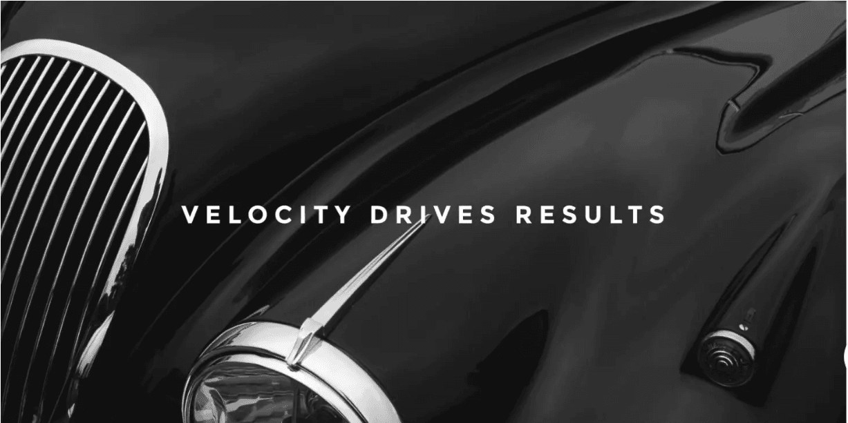 Classic black car with the words Velocity Drives Results